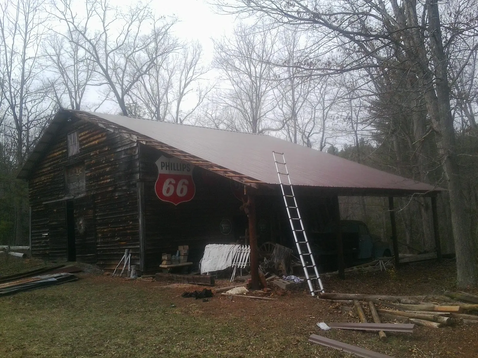 New metal roof on an open sided timber barn with a vintage sign in Pierson